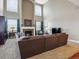 Spacious living room featuring a fireplace, large windows, and a comfortable brown sectional sofa at 3309 Springbriar Dr, Castle Rock, CO 80109