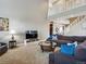 Spacious living room offering comfortable seating, plenty of natural light, and access to the upper level at 3309 Springbriar Dr, Castle Rock, CO 80109