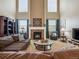 Inviting living room features a fireplace with decorative mantle and a cozy brown sectional sofa at 3309 Springbriar Dr, Castle Rock, CO 80109