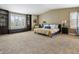 Spacious main bedroom with built-in shelving, a bay window, and ample carpeted floor space for relaxation at 3309 Springbriar Dr, Castle Rock, CO 80109