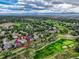 Aerial view of house, golf course, neighborhood, and scenic mountain views in the distance at 3462 W 109Th Cir, Westminster, CO 80031