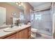 Bathroom featuring a large mirror, granite countertops and a glass-enclosed shower at 3462 W 109Th Cir, Westminster, CO 80031