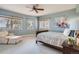 Bright bedroom featuring a ceiling fan, carpeted floors, and three windows with natural light at 3462 W 109Th Cir, Westminster, CO 80031