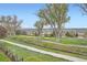 Golf course view with walking path, mature trees, green grass, and mountain views at 3462 W 109Th Cir, Westminster, CO 80031