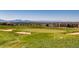 Picturesque golf course view with rolling green hills and mountain views in the background at 3462 W 109Th Cir, Westminster, CO 80031