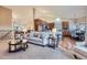 Open-concept living room with vaulted ceilings flowing into the kitchen and dining room, offering ample natural light at 3462 W 109Th Cir, Westminster, CO 80031