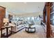 Bright living room with a fireplace and open access to the kitchen and outdoor deck at 3462 W 109Th Cir, Westminster, CO 80031