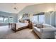 Relaxing main bedroom featuring vaulted ceilings, natural light, and cozy sitting area at 3462 W 109Th Cir, Westminster, CO 80031