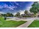 A community pool surrounded by lounge chairs, tables, umbrellas, a clubhouse, and grassy areas at 3462 W 109Th Cir, Westminster, CO 80031