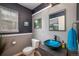 Modern bathroom with unique blue sink and dark walls at 4700 Waldenwood Dr, Highlands Ranch, CO 80130