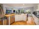 Kitchen with island, stainless steel appliances, and white cabinets at 4700 Waldenwood Dr, Highlands Ranch, CO 80130