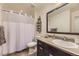 Bathroom featuring a shower behind a white curtain, a black mirror, and towel storage at 3477 New Haven Cir, Castle Rock, CO 80109