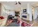 Open living area boasts a modern fireplace, hardwood floors, and access to other parts of the home at 3477 New Haven Cir, Castle Rock, CO 80109