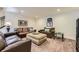 Inviting living room featuring plush leather sofas, recessed lighting, and a stylish upholstered ottoman at 3477 New Haven Cir, Castle Rock, CO 80109