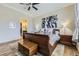 A traditional main bedroom with a ceiling fan, a wooden chest, and an attached bathroom at 3477 New Haven Cir, Castle Rock, CO 80109