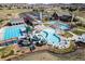 Aerial view of community pool area featuring multiple pools, slides, and lounge areas at 3477 New Haven Cir, Castle Rock, CO 80109