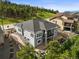 Aerial view of a two-story gray home with backyard landscaping and stone walkway at 16312 Morning Rise Ln, Monument, CO 80132