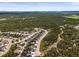 Panoramic aerial view of a residential neighborhood surrounded by lush green forests and scenic landscape at 16312 Morning Rise Ln, Monument, CO 80132