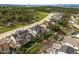 Aerial view showcases the gray home with landscaped yards amid neighborhood trees and hillside at 16312 Morning Rise Ln, Monument, CO 80132