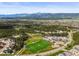 Panoramic aerial view of community park, soccer field, playground and breathtaking mountain views at 16312 Morning Rise Ln, Monument, CO 80132
