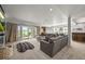 Spacious basement with a gray sectional sofa, a fireplace, and access to the outdoor patio for relaxation and entertainment at 16312 Morning Rise Ln, Monument, CO 80132