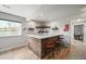 Stylish home bar in basement with a wood facade, quartz countertop, and custom shelving for an entertainment space at 16312 Morning Rise Ln, Monument, CO 80132