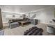 Basement with gray sectional sofa, ping pong table, and wet bar create a welcoming space for leisure and entertaining at 16312 Morning Rise Ln, Monument, CO 80132