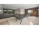 Recreational basement area with a ping pong table, a modern sectional sofa, and a rustic wood accent wall at 16312 Morning Rise Ln, Monument, CO 80132