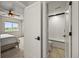 Bright bathroom with white subway tile, bathtub, and an open doorway to the bedroom at 16312 Morning Rise Ln, Monument, CO 80132