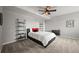 Modern bedroom with plush carpet, ceiling fan, minimalist decor and a large comfy queen bed at 16312 Morning Rise Ln, Monument, CO 80132