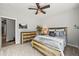 Bedroom with a ceiling fan, carpet, and rustic wood furnishings at 16312 Morning Rise Ln, Monument, CO 80132