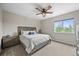 Comfortable bedroom with plush carpet, a modern ceiling fan, and a window to the backyard at 16312 Morning Rise Ln, Monument, CO 80132
