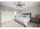 Neutral bedroom with comfortable queen bed, dresser, ceiling fan, and a view to the backyard at 16312 Morning Rise Ln, Monument, CO 80132