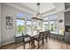 Bright dining room with large windows, bench seating, and modern chandelier at 16312 Morning Rise Ln, Monument, CO 80132