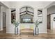 Warm and welcoming foyer featuring wood floors, a decorative bench, and views into the living spaces at 16312 Morning Rise Ln, Monument, CO 80132