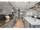 Spacious kitchen with gray cabinetry, stainless appliances, hardwood floors, and a large center island at 16312 Morning Rise Ln, Monument, CO 80132