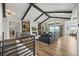 Open living room boasts vaulted ceilings with beams, built-in cabinets, and picturesque views at 16312 Morning Rise Ln, Monument, CO 80132