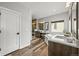 Well-lit bathroom featuring a soaking tub, dual sinks, vanity and a wood-paneled shower at 16312 Morning Rise Ln, Monument, CO 80132