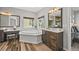 Bathroom features a soaking tub, dual sinks, a vanity and views from the window at 16312 Morning Rise Ln, Monument, CO 80132