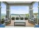 Enjoy serene mountain views from this covered outdoor patio with comfortable seating and stylish decor at 16312 Morning Rise Ln, Monument, CO 80132