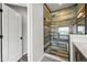 Bathroom shower with attractive wood-look tiling and glass door enclosure at 16312 Morning Rise Ln, Monument, CO 80132