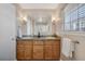 Bathroom featuring a double vanity, tile countertops, a neutral color palette, and decorative lighting at 3866 S Dallas Cir # 201, Aurora, CO 80014