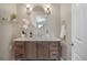 Stylish bathroom vanity with a marble countertop, oval mirror and modern lighting fixtures create an inviting atmosphere at 3866 S Dallas Cir # 201, Aurora, CO 80014