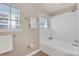 Bright bathroom featuring a tub and shower, tiled floor and walls, and a bright, light-filled window at 3866 S Dallas Cir # 201, Aurora, CO 80014