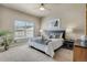 Comfortable bedroom featuring neutral tones, bright natural light, and modern ceiling fan at 3866 S Dallas Cir # 201, Aurora, CO 80014