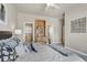 View of the bed with decorative pillows, built in bookshelf, and closets at 3866 S Dallas Cir # 201, Aurora, CO 80014
