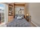 Bedroom featuring a Murphy bed with built-in cabinetry and adjacent outdoor balcony at 3866 S Dallas Cir # 201, Aurora, CO 80014
