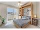Cozy bedroom featuring a Murphy bed, built-in shelving, and a large glass patio door at 3866 S Dallas Cir # 201, Aurora, CO 80014