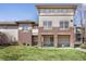 Inviting exterior of townhome featuring brick accents, private covered porch, and lush green lawn at 3866 S Dallas Cir # 201, Aurora, CO 80014