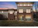 Multi-level condo building with brick facade, private balconies, and well-maintained lawn at 3866 S Dallas Cir # 201, Aurora, CO 80014